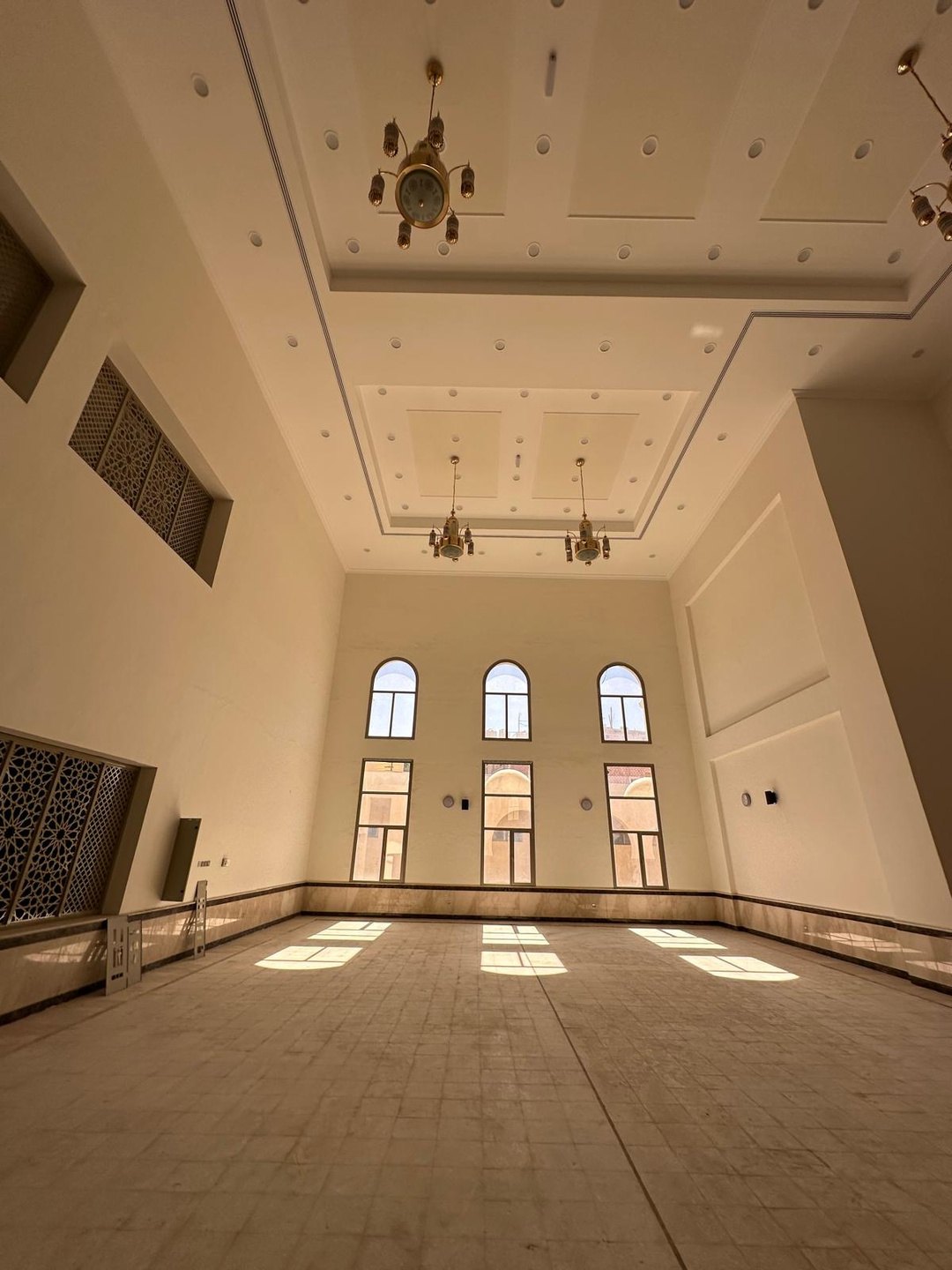 Prayer hall with arched windows and daylight