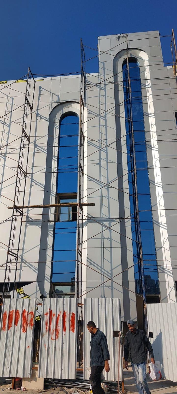 Arched glazing and cladding junctions resolved on site to the approved detail.